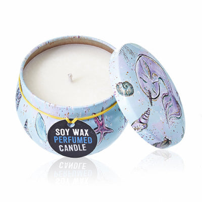 Soy wax perfumed candle in a decorative tin with a mermaid design on a white background