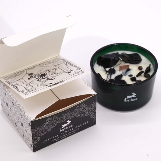 Frosted candle in a black holder with a decorative box on a white background