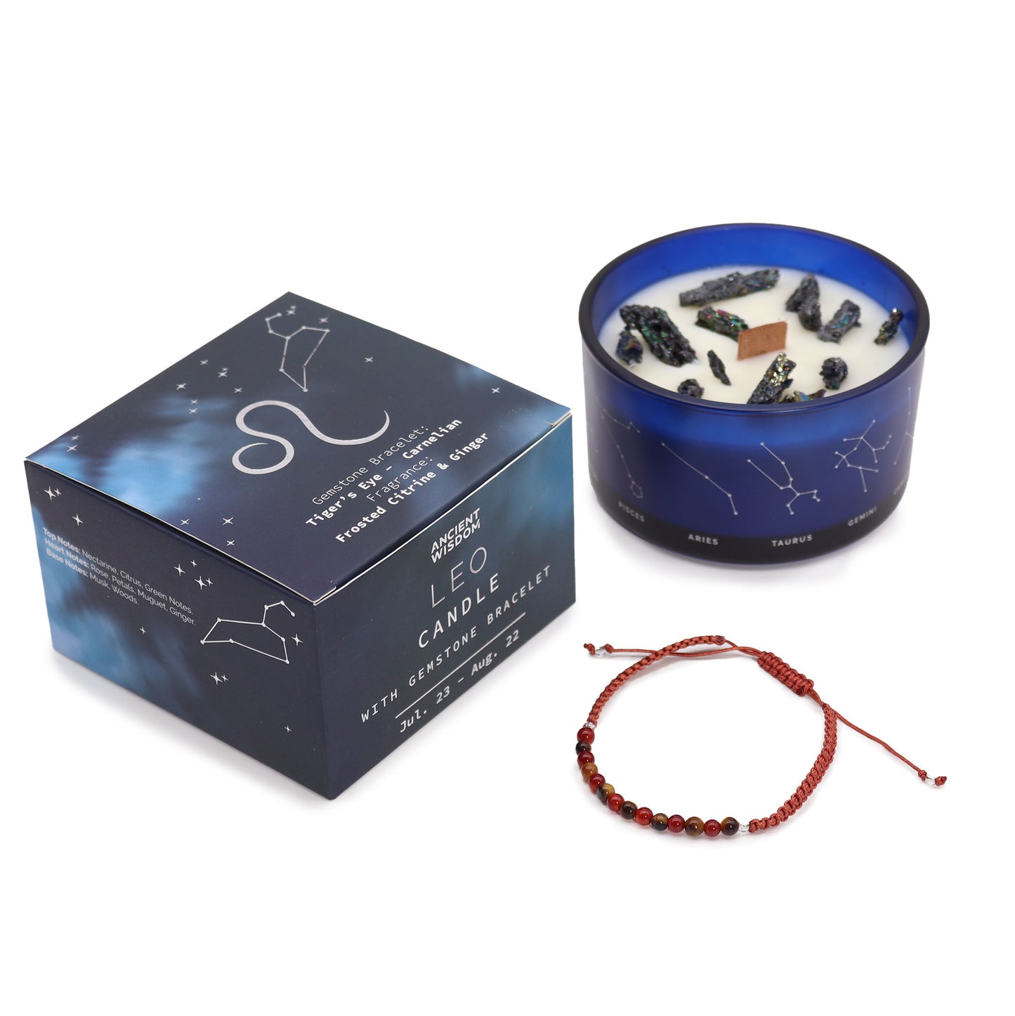 A blue glass candle container with a white candle inside, alongside a gemstone bracelet, with a box that has zodiac constellations.