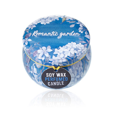 Soy wax perfumed candle in a decorative blue container with floral design on a white background