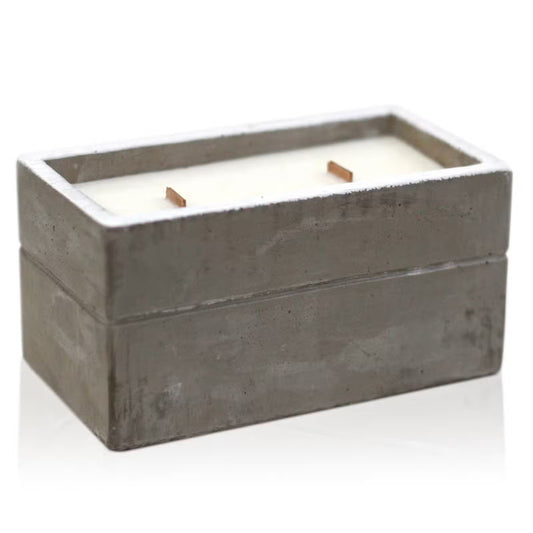 Candle in a concrete container on a white background