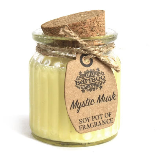 Glass jar with cork lid containing a candle labeled 'Mystic Musk' by Bamboo Soy Pot of Fragrance on a white background.