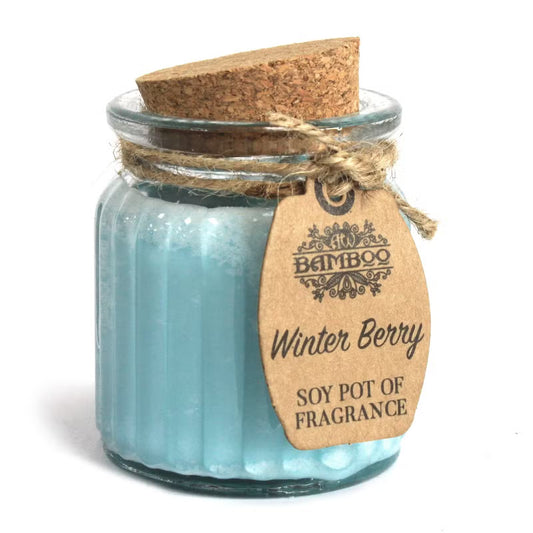 Scented candle in a glass jar with a cork lid and 'Bamboo' brand tag on a white background