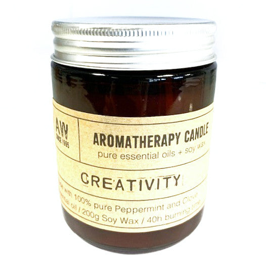 Aromatherapy candle jar with label that reads 'Creativity', indicating the scent profile of the candle.