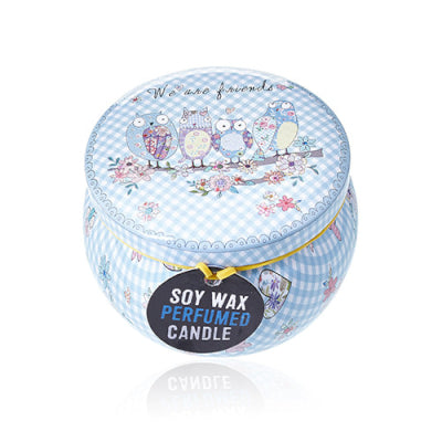 Candle jar with decorative lid featuring owls and flowers on a white background