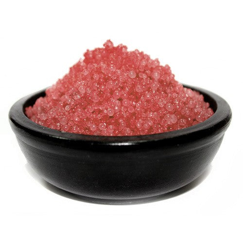 A black bowl filled with red simmering granules
