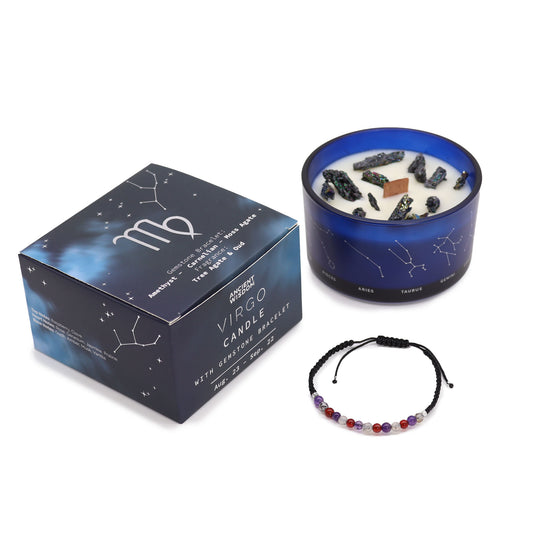 A soy wax candle in a blue container with a mix of crystals on top, next to its black and blue box packaging and a gemstone bracelet.