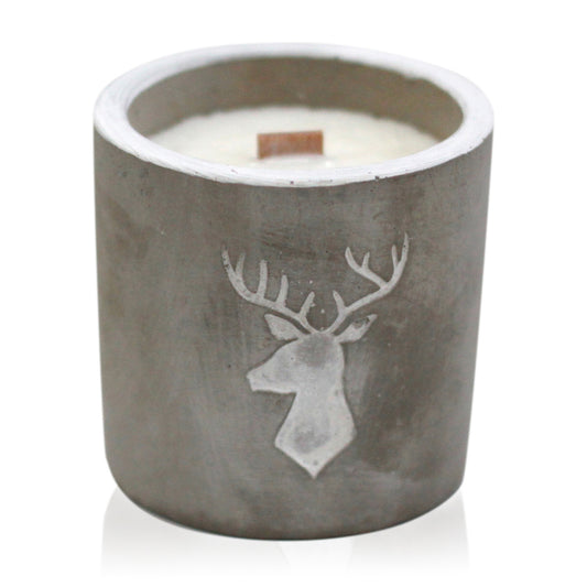 A concrete candle with a wooden wick and a deer head design, filled with a white wax.